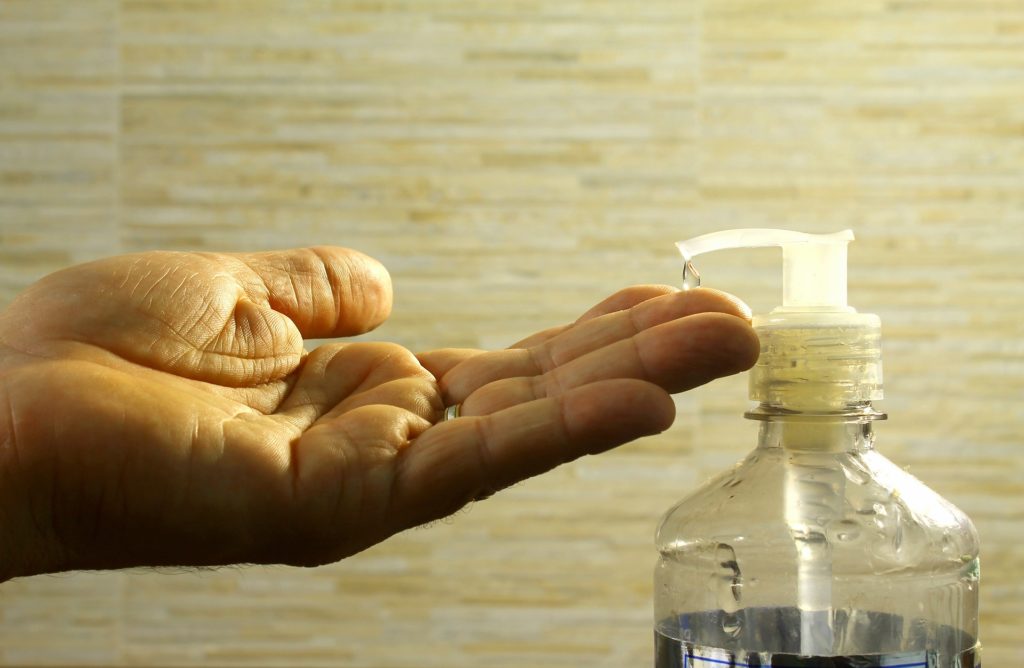 hand with disinfectant pump